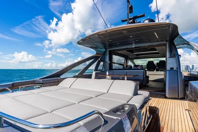 Unreel Yacht Photos Pics 2023 Pershing 7X luxury yacht with sleek design and spacious deck on open sea.