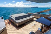 Luxurious 2023 Pershing 7X yacht deck with seating, overlooking the ocean.