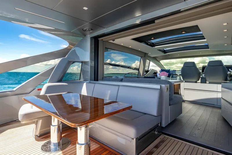 Unreel Yacht Photos Pics Luxurious 2023 Pershing 7X yacht interior with ocean view and modern seating area.
