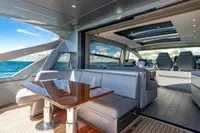 Luxurious 2023 Pershing 7X yacht interior with ocean view and modern seating area.