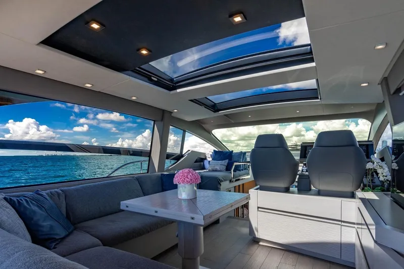 Unreel Yacht Photos Pics Luxurious interior of 2023 Pershing 7X yacht with panoramic ocean views and modern seating.