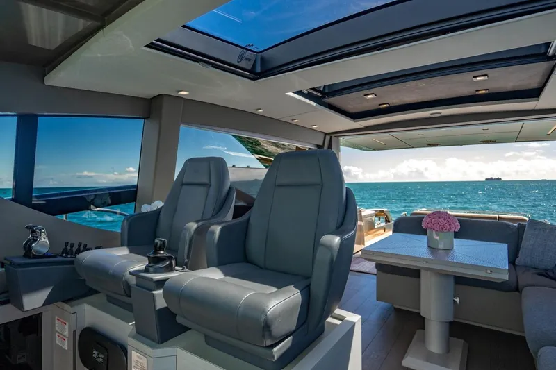 Unreel Yacht Photos Pics Luxurious interior of 2023 Pershing 7X yacht with ocean view and modern seating.