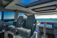 Luxurious interior of 2023 Pershing 7X yacht with ocean view and modern seating.