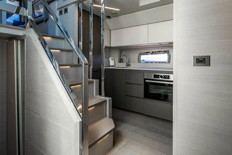 Unreel Yacht Photos Pics Modern kitchen interior on 2023 Pershing 7X yacht, featuring sleek cabinetry and stainless steel appliances.