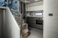 Modern kitchen interior on 2023 Pershing 7X yacht, featuring sleek cabinetry and stainless steel appliances.