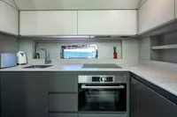 Modern kitchen interior on 2023 Pershing 7X yacht with sleek appliances and ocean view.