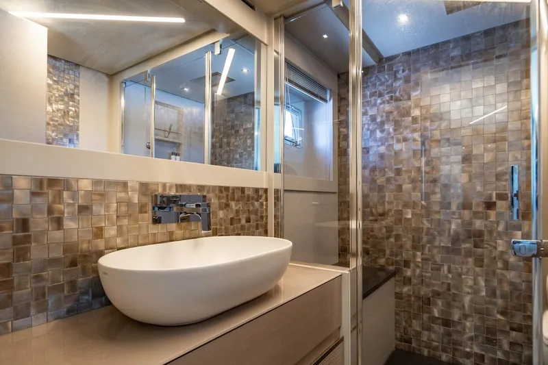 Unreel Yacht Photos Pics Luxurious bathroom in 2023 Pershing 7X yacht with modern sink and mosaic tiles.