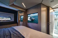 Luxurious interior of 2023 Pershing 7X yacht with modern bedroom and scenic window view.