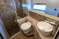 Luxurious bathroom in 2023 Pershing 7X yacht with modern fixtures and ocean view.