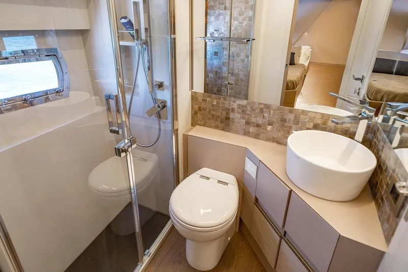 Unreel Yacht Photos Pics Luxurious bathroom in 2023 Pershing 7X yacht with modern fixtures and elegant design.