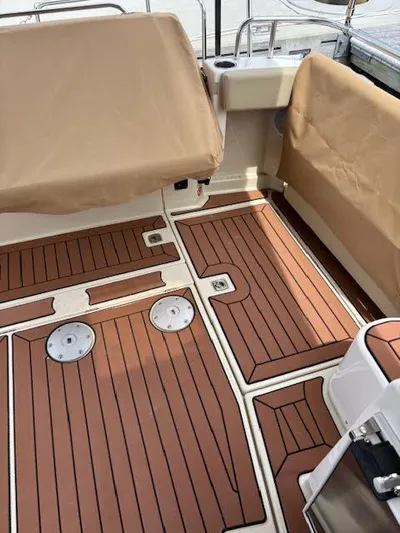 Marcia Jean Yacht Photos Pics 2023 Ranger Tugs R-29 S boat deck with wood finish and beige covers.