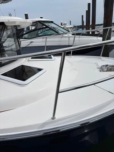 Marcia Jean Yacht Photos Pics 2023 Ranger Tugs R-29 S boat docked at marina, showcasing sleek design and windows.