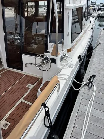 Marcia Jean Yacht Photos Pics 2023 Ranger Tugs R-29 S docked, showcasing elegant deck and steering wheel.