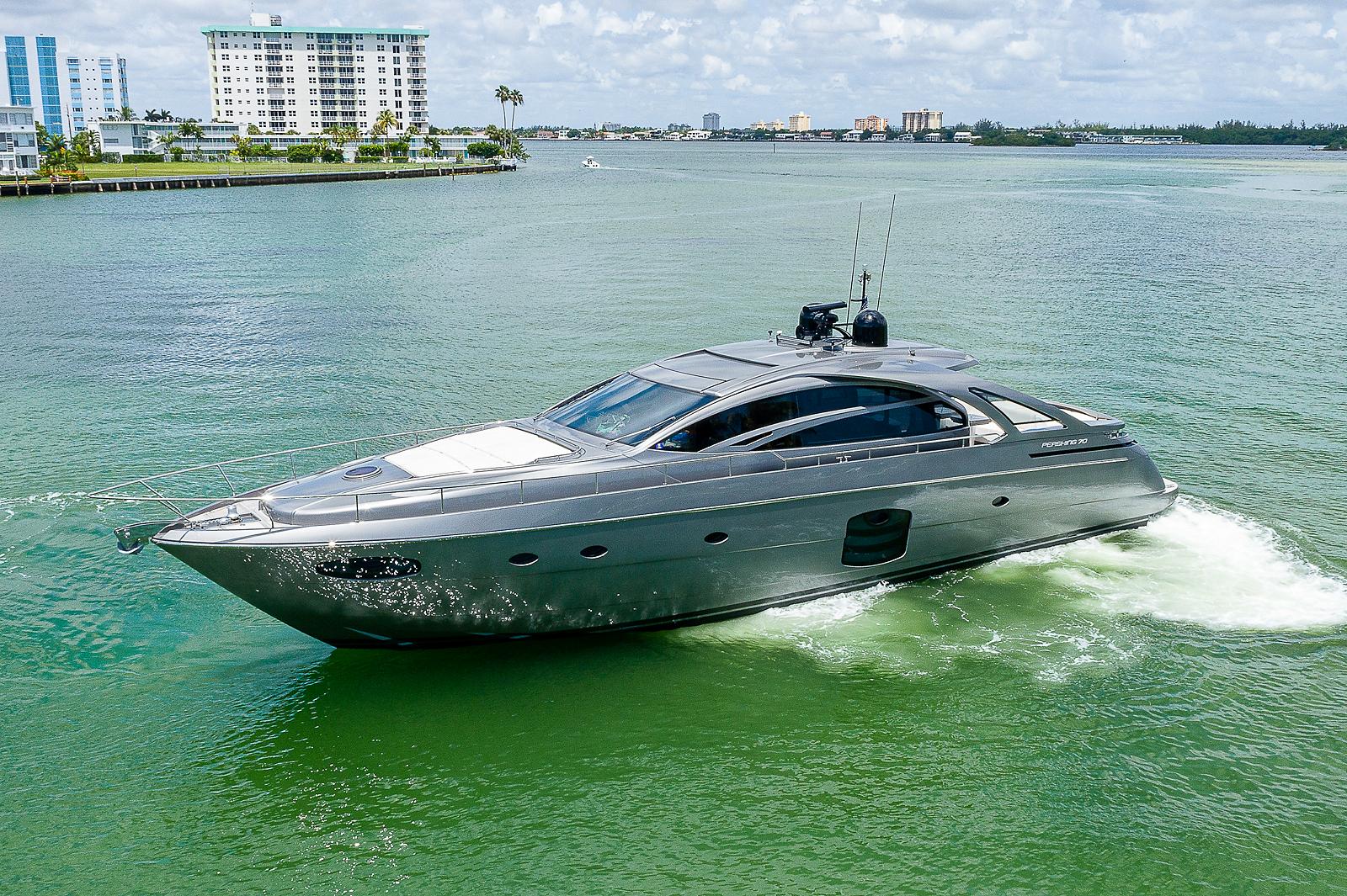 2015 Pershing 70 yacht cruising on a sunny day in a coastal waterway.