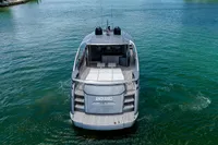 2015 Pershing 70 yacht on clear water, rear view.