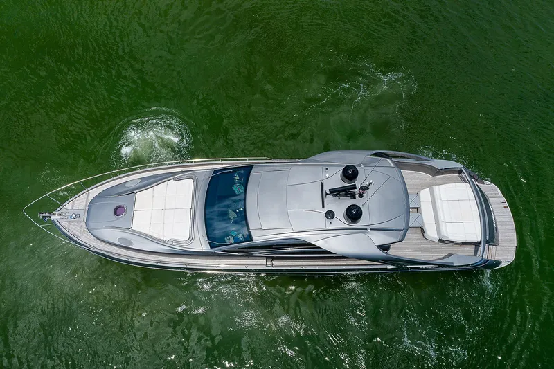 Andiamo Yacht Photos Pics Aerial view of a 2015 Pershing 70 yacht cruising on green water.