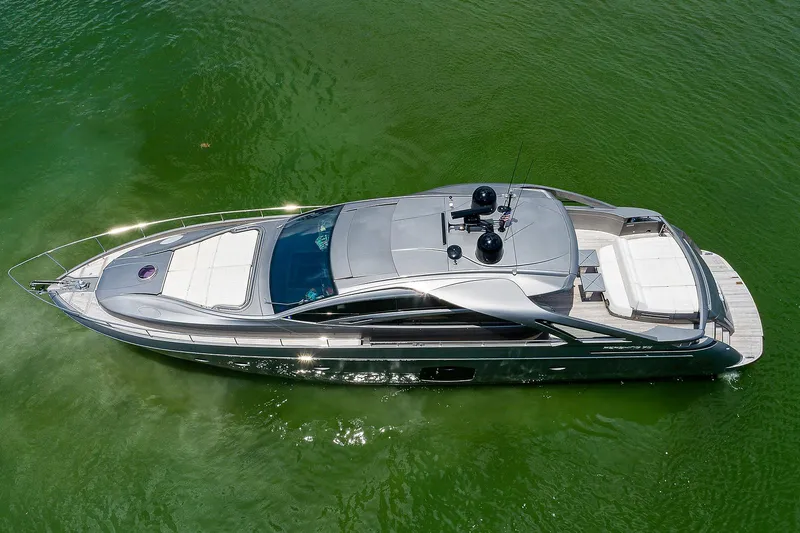 Andiamo Yacht Photos Pics 2015 Pershing 70 yacht cruising on calm green waters, aerial view.
