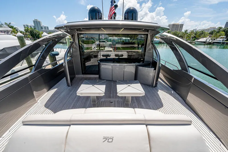 Andiamo Yacht Photos Pics Luxury 2015 Pershing 70 yacht with sleek design and spacious deck in marina setting.