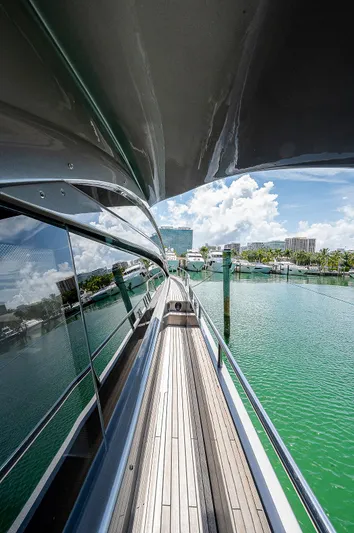 Andiamo Yacht Photos Pics Side view of 2015 Pershing 70 yacht docked in a marina with clear skies.
