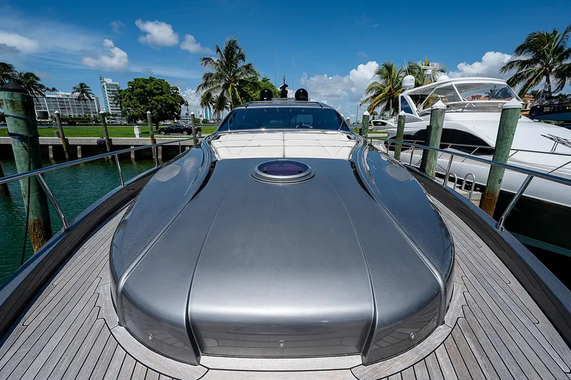 Andiamo Yacht Photos Pics 2015 Pershing 70 yacht docked, sleek design, sunny day, palm trees in background.