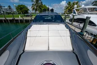 2015 Pershing 70 yacht docked, featuring sleek design and sunbathing area.
