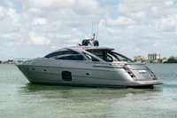 2015 Pershing 70 yacht on calm water under a cloudy sky.