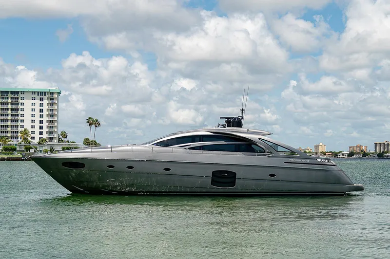 Andiamo Yacht Photos Pics 2015 Pershing 70 yacht on calm water with cityscape background.