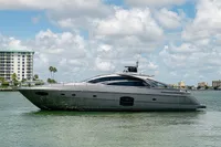 2015 Pershing 70 yacht on calm water with cityscape background.