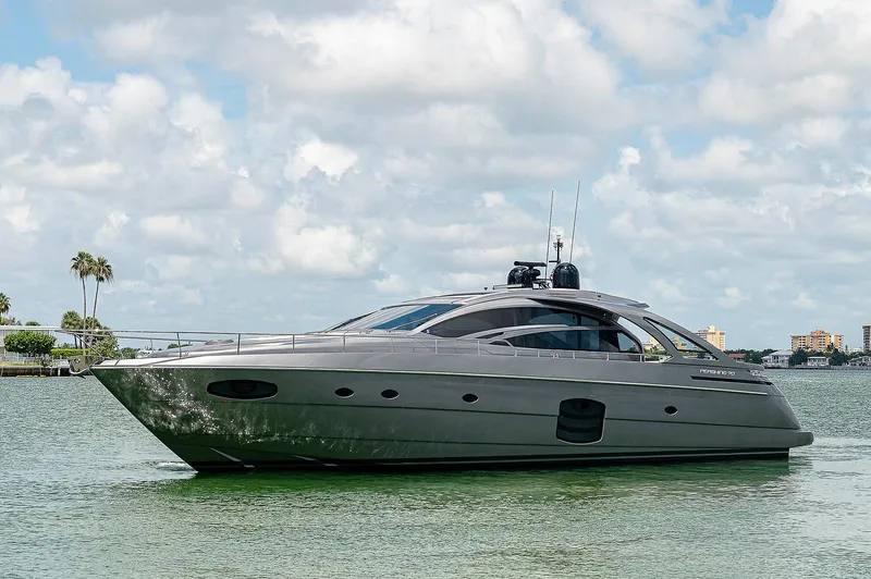 Andiamo Yacht Photos Pics Luxury 2015 Pershing 70 yacht cruising on calm waters under a partly cloudy sky.