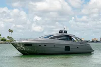 Luxury 2015 Pershing 70 yacht cruising on calm waters under a partly cloudy sky.