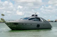 2015 Pershing 70 yacht on calm water under a partly cloudy sky.