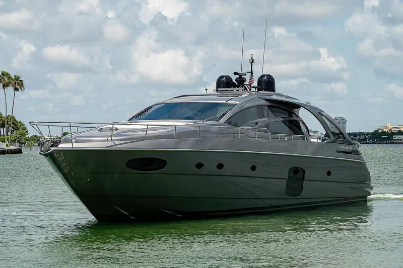 Andiamo Yacht Photos Pics 2015 Pershing 70 yacht cruising on a calm, scenic waterway under a cloudy sky.