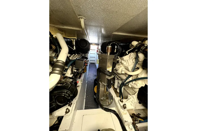  Yacht Photos Pics Engine room of 2003 Hatteras 60 Convertible yacht, showcasing mechanical components and piping.