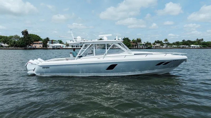 Intrepid Yacht Photos Pics 2013 Intrepid 400 Cuddy boat on calm water, under a partly cloudy sky.