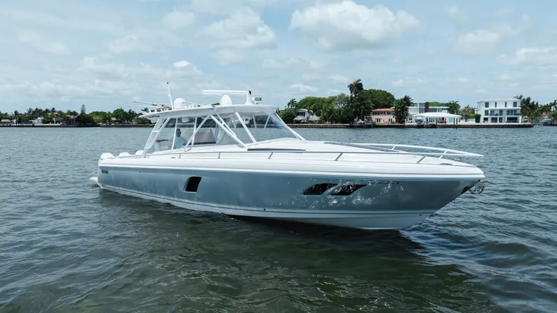 Intrepid Yacht Photos Pics 2013 Intrepid 400 Cuddy boat on calm water, showcasing sleek design and modern features.