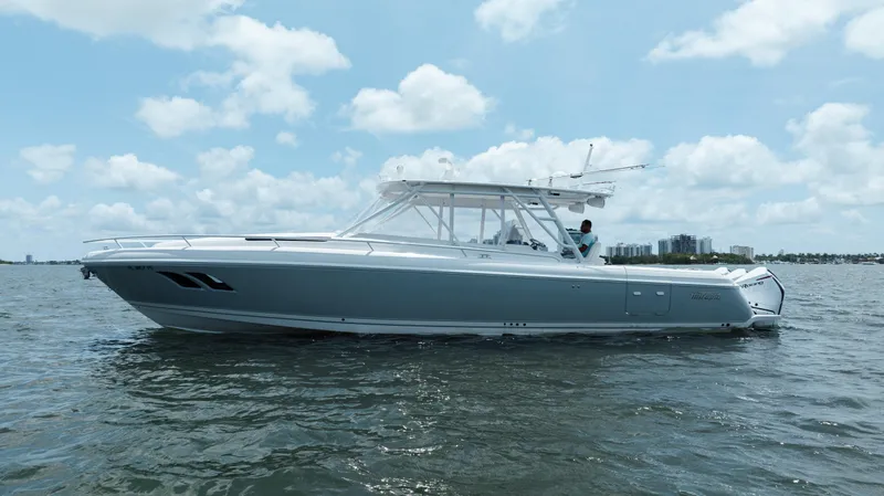 Intrepid Yacht Photos Pics 2013 Intrepid 400 Cuddy boat on calm water under a partly cloudy sky.