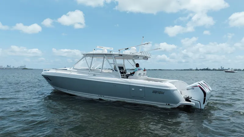 Intrepid Yacht Photos Pics 2013 Intrepid 400 Cuddy boat on calm water under a partly cloudy sky.