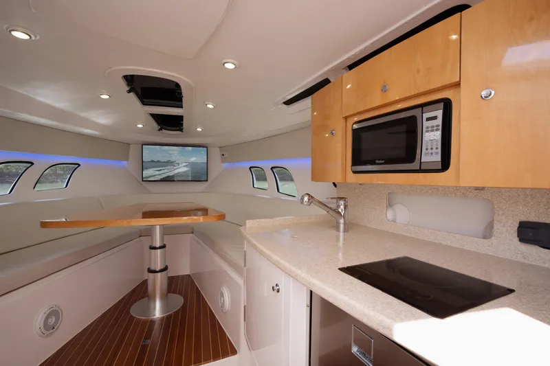 Intrepid Yacht Photos Pics Interior of 2013 Intrepid 400 Cuddy yacht with kitchenette and seating area.