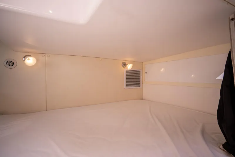 Intrepid Yacht Photos Pics Interior cabin of 2013 Intrepid 400 Cuddy, featuring cozy sleeping area with lighting.