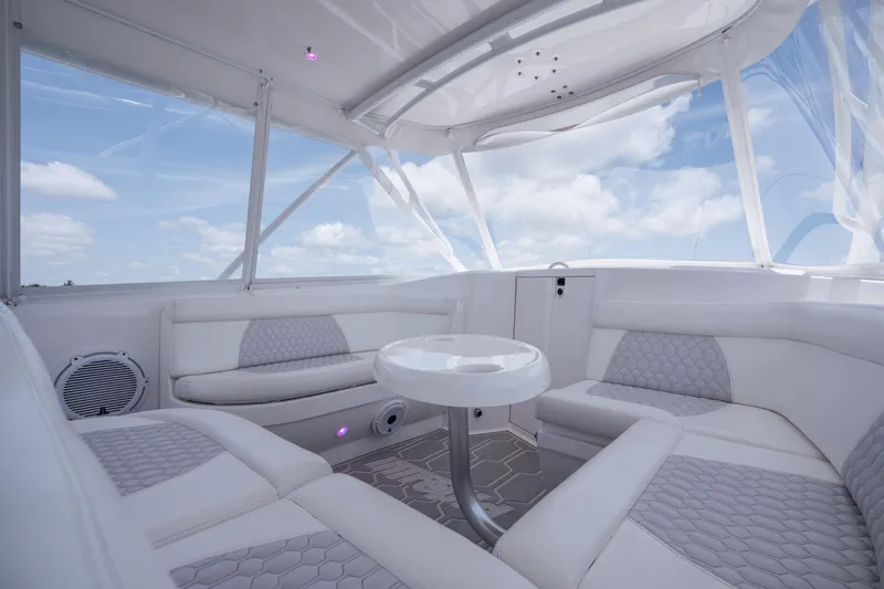 Intrepid Yacht Photos Pics Luxurious interior of 2013 Intrepid 400 Cuddy boat with white seating and table.