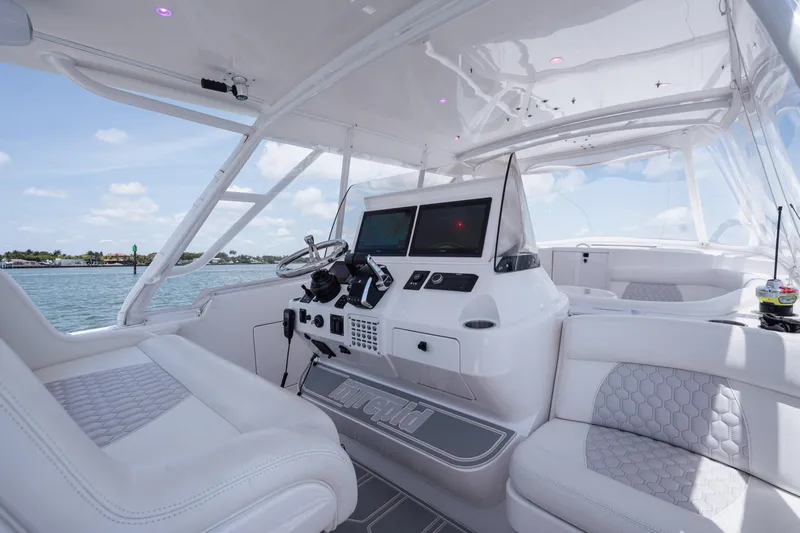 Intrepid Yacht Photos Pics 2013 Intrepid 400 Cuddy boat interior with modern helm and seating, on a sunny day.