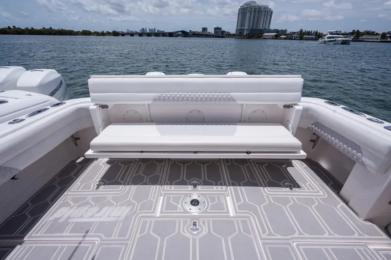 Intrepid Yacht Photos Pics 2013 Intrepid 400 Cuddy boat with spacious deck and seating, overlooking calm waters.