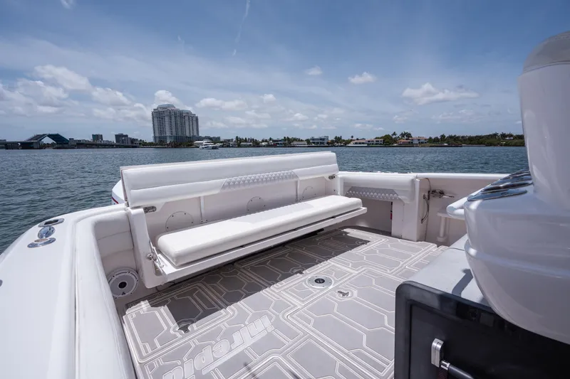 Intrepid Yacht Photos Pics 2013 Intrepid 400 Cuddy boat with spacious seating and scenic waterfront view.