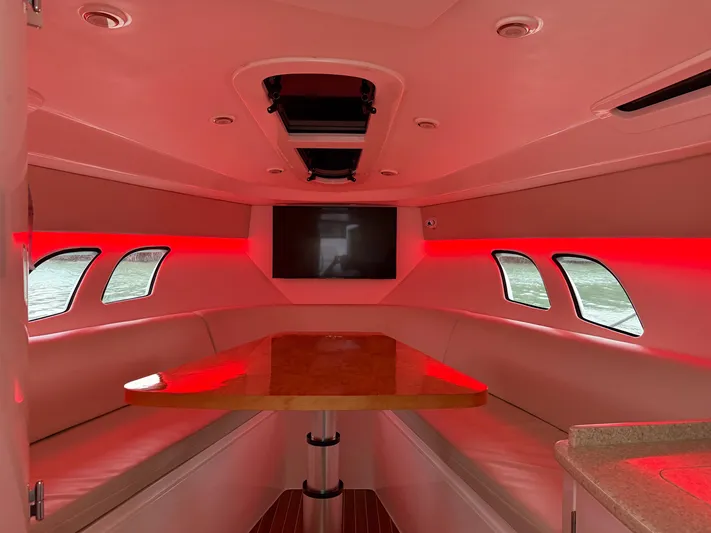 Intrepid Yacht Photos Pics Interior of 2013 Intrepid 400 Cuddy with red lighting and seating area.