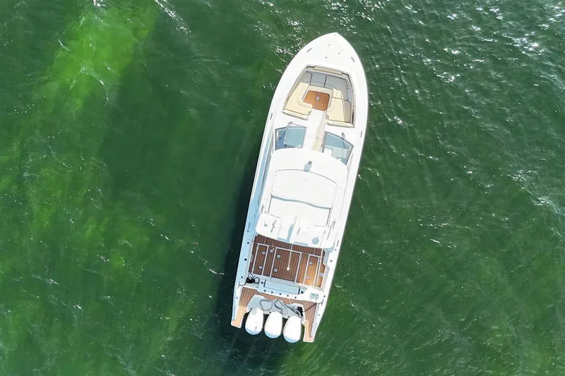 Lady B Yacht Photos Pics Aerial view of 2019 Pursuit DC 365 Dual Console boat on green water.