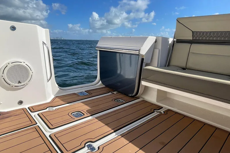 Lady B Yacht Photos Pics 2019 Pursuit DC 365 Dual Console boat interior with teak flooring and ocean view.