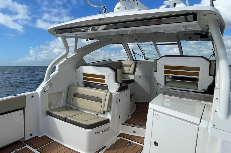 Lady B Yacht Photos Pics 2019 Pursuit DC 365 Dual Console boat interior with seating and ocean view.