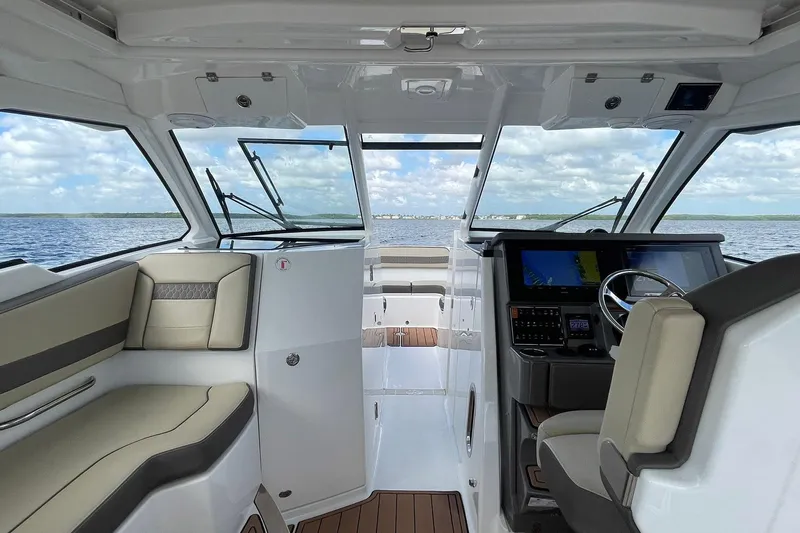 Lady B Yacht Photos Pics 2019 Pursuit DC 365 Dual Console interior with helm, seating, and navigation screens on open water.
