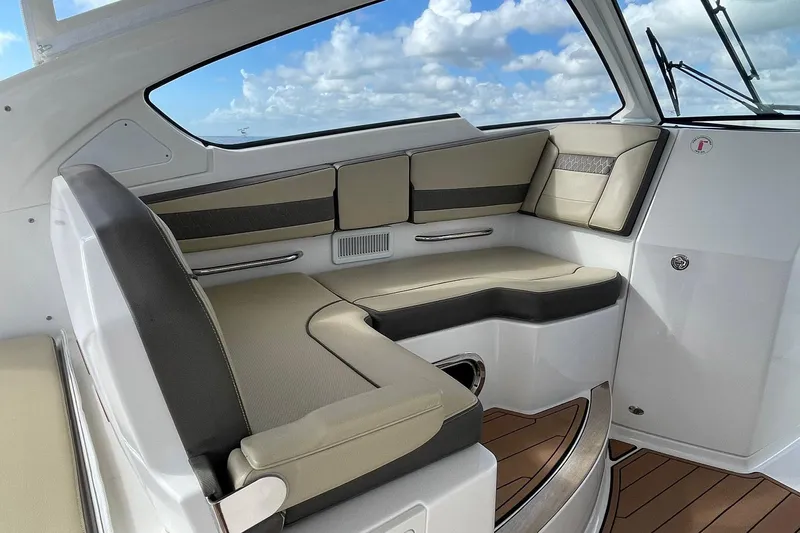 Lady B Yacht Photos Pics 2019 Pursuit DC 365 Dual Console interior with cushioned seating and wood flooring.