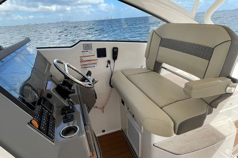 Lady B Yacht Photos Pics 2019 Pursuit DC 365 Dual Console helm with steering wheel and comfortable seating.